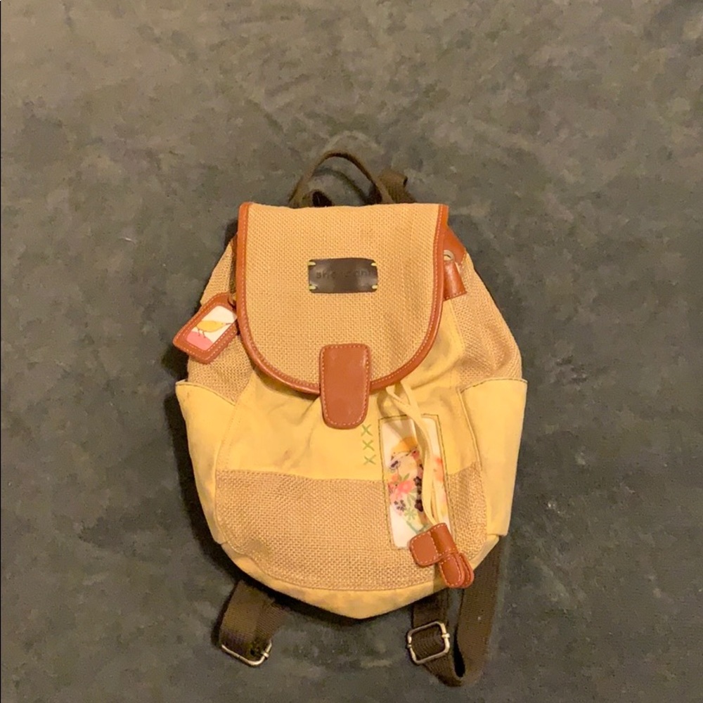 Sherpani tan bag with a bird and flower design
